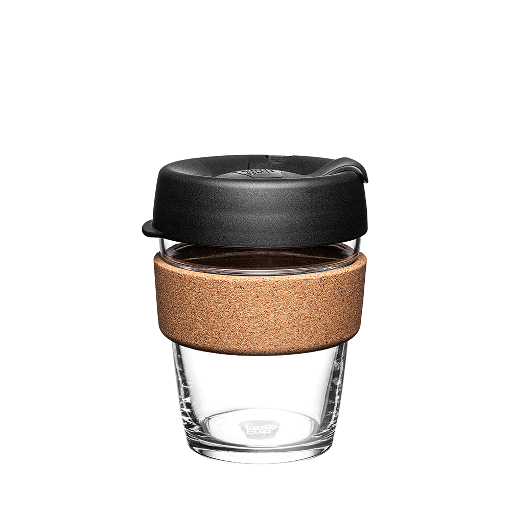 KeepCup Brew Cork M 12oz in Black, featuring a clear tempered glass cup with natural cork band and black press-fit lid with sipper, photographed front-on against a white background.