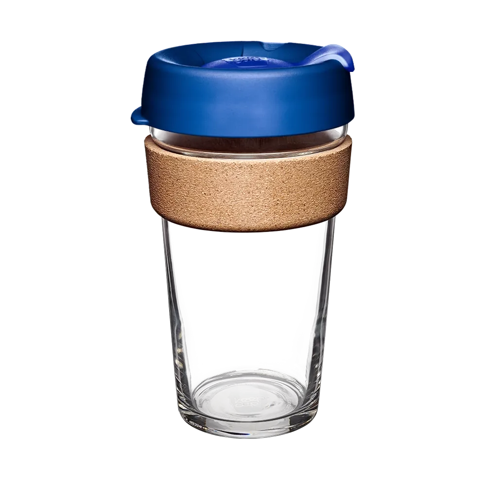 KeepCup Brew Cork L 16oz in Electric Blue, shown against a white background. The reusable cup features a clear glass body, natural cork band for heat protection, and a blue plastic lid with sip-through opening.
