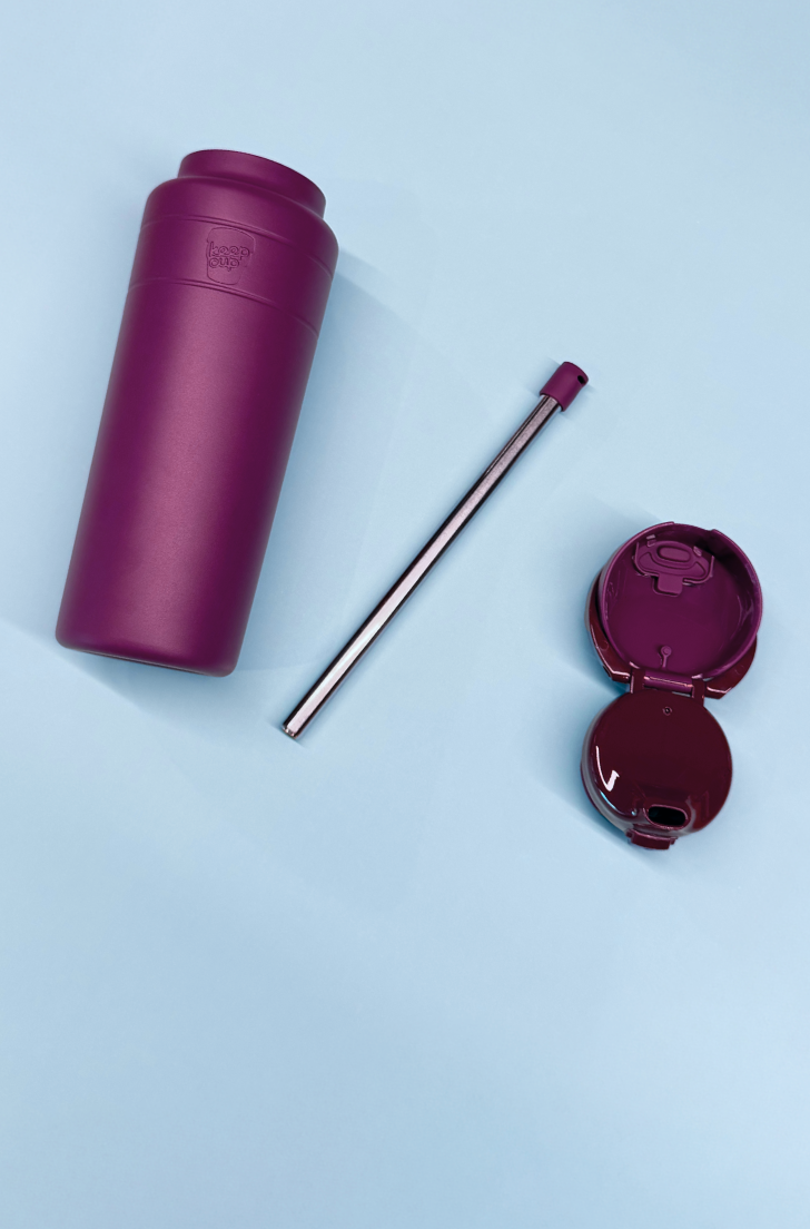 Ora bottle in mulberry disassembled in bottle base, straw and lid