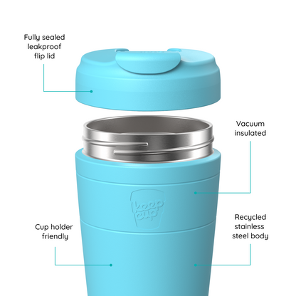 A light blue insulated KeepCup travel tumbler with a flip lid shown disassembled to highlight features, with callout lines and text reading 'Fully sealed leakproof flip lid,' 'Vacuum insulated,' 'Recycled stainless steel body,' and 'Cup holder friendly.' The embossed logo on the tumbler reads 'koo cup.