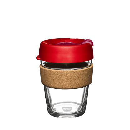 KeepCup Brew Cork M 12oz in Dawnbreak, featuring a clear tempered glass cup with natural cork band and red lid with sipper opening, shown from a straight-on angle against a white background.