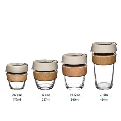 Set of four reusable cups with cork band in different sizes on a white background