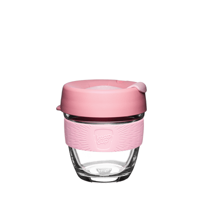 Glass KeepCup reusable coffee cup with pink silicone lid on a white background