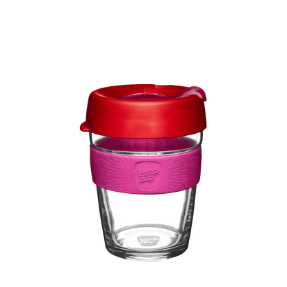 KeepCup reusable glass coffee cup with red lid, pink silicone band and clear glass body on white background