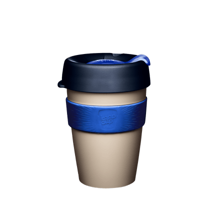 KeepCup Original M 12oz in Ink colour, featuring a beige cup body, dark navy lid with blue plug, and blue silicone band with embossed KeepCup logo, shown against a white background.