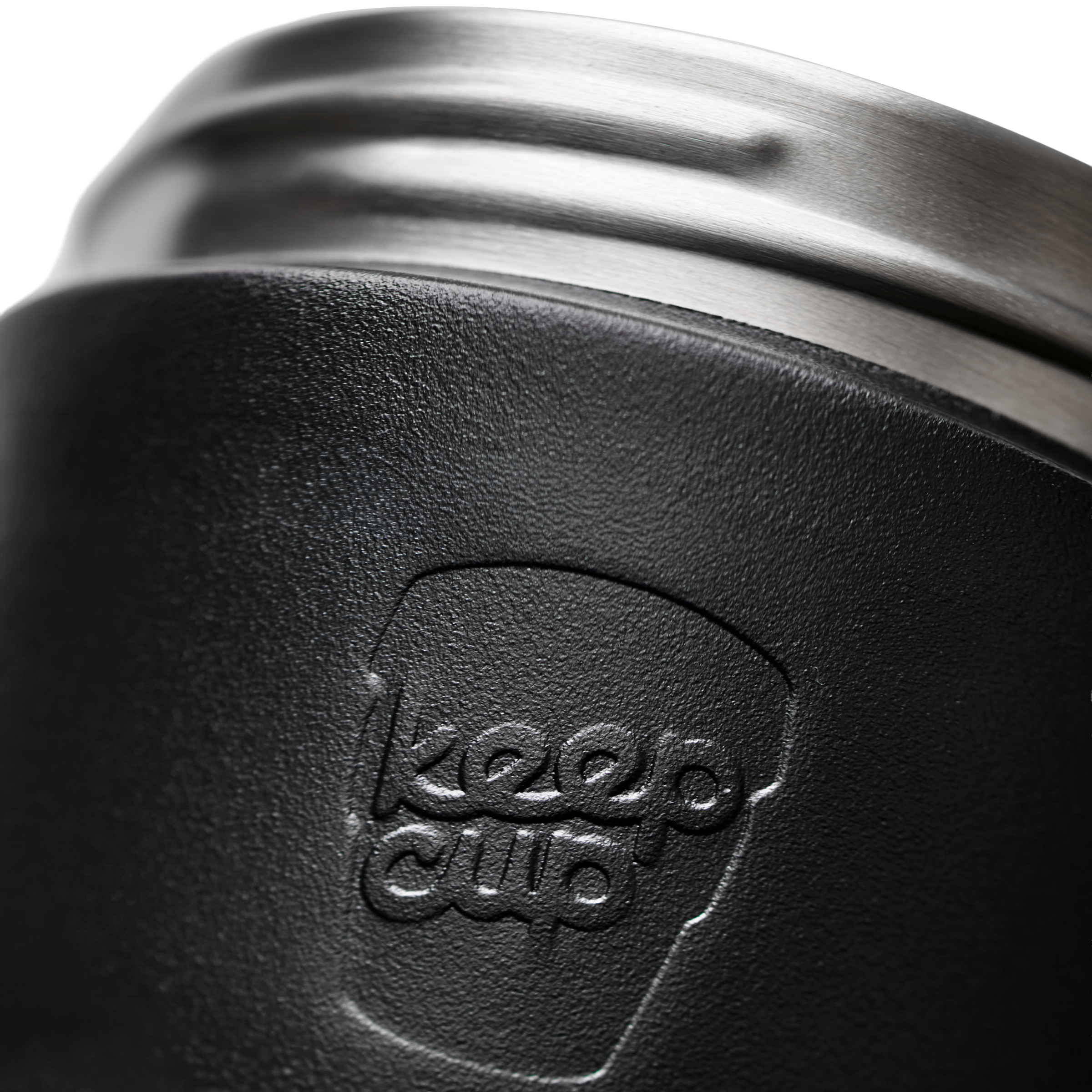 Close-up of a black textured insulated KeepCup commuter travel mug with a brushed silver metal rim and an embossed KeepCup logo on the front.