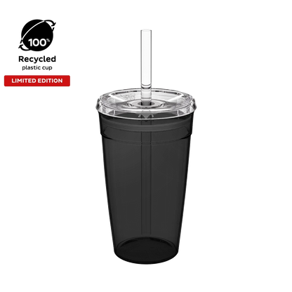 Cold Cup Original L 16oz in Recycled Black, shown from a front angle against a white background, featuring a translucent black cup body, clear lid with straw hole, and clear reusable straw. Badges indicate 100% recycled plastic cup and limited edition.