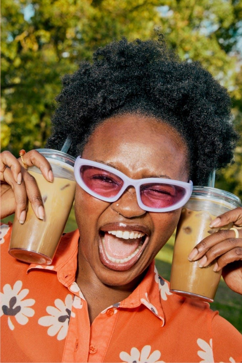 Woman holding KeepCup Sip & Chill Original Clear reusable cup with iced coffee and iced tea