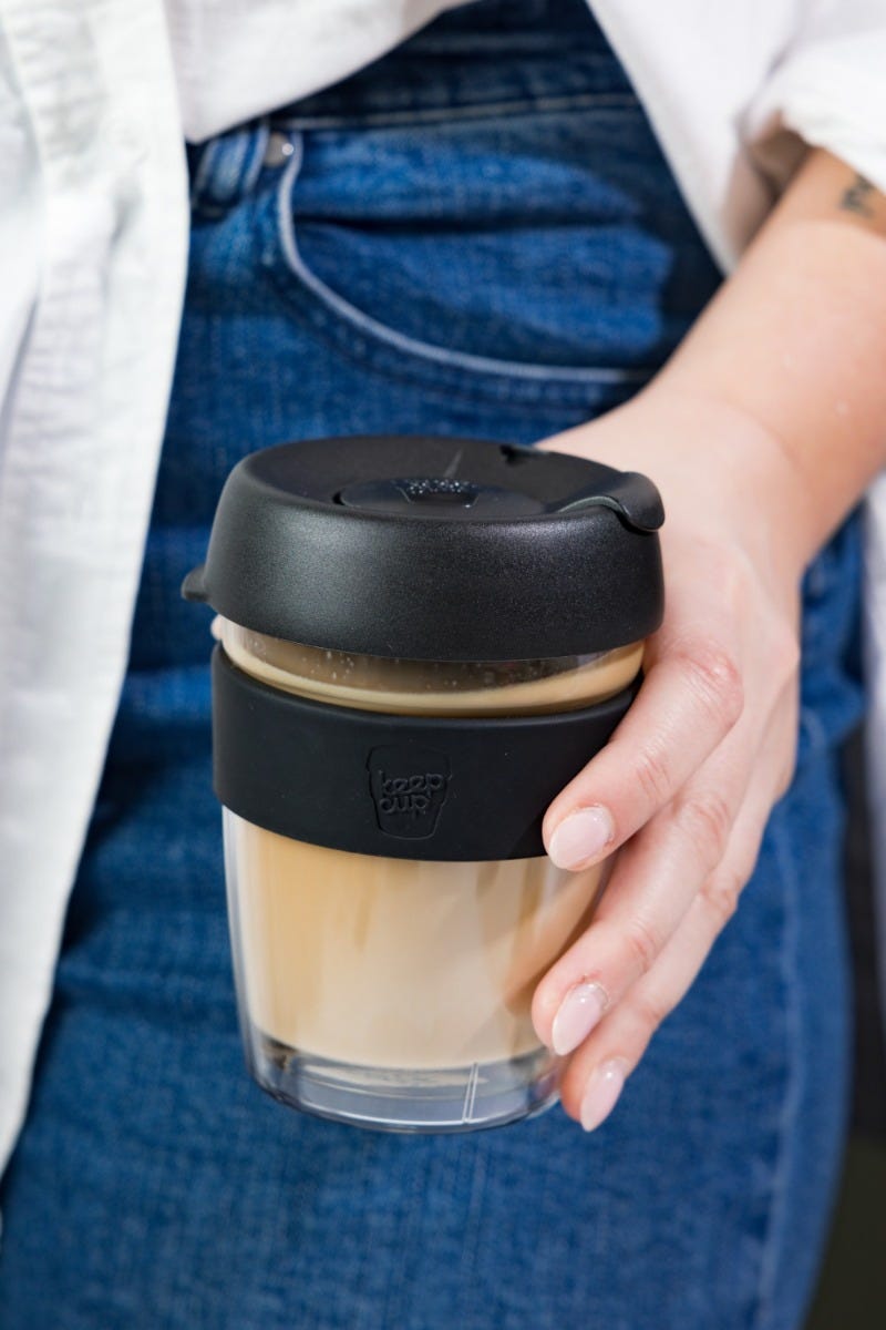Woman holding KeepCup Brew Longplay 12oz with coffee