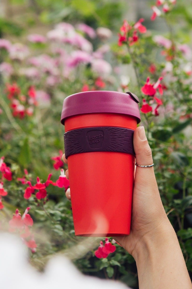 Woman holding KeepCup Original Large 16oz cup in the garden