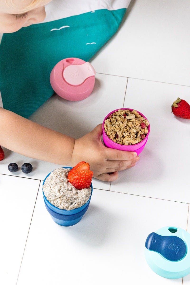 Child lifting KeepCup Original XS 4oz cup filled with granola