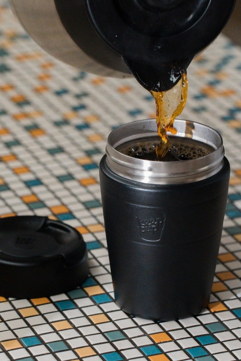 Woman holding KeepCup Traveller 12oz with coffee
