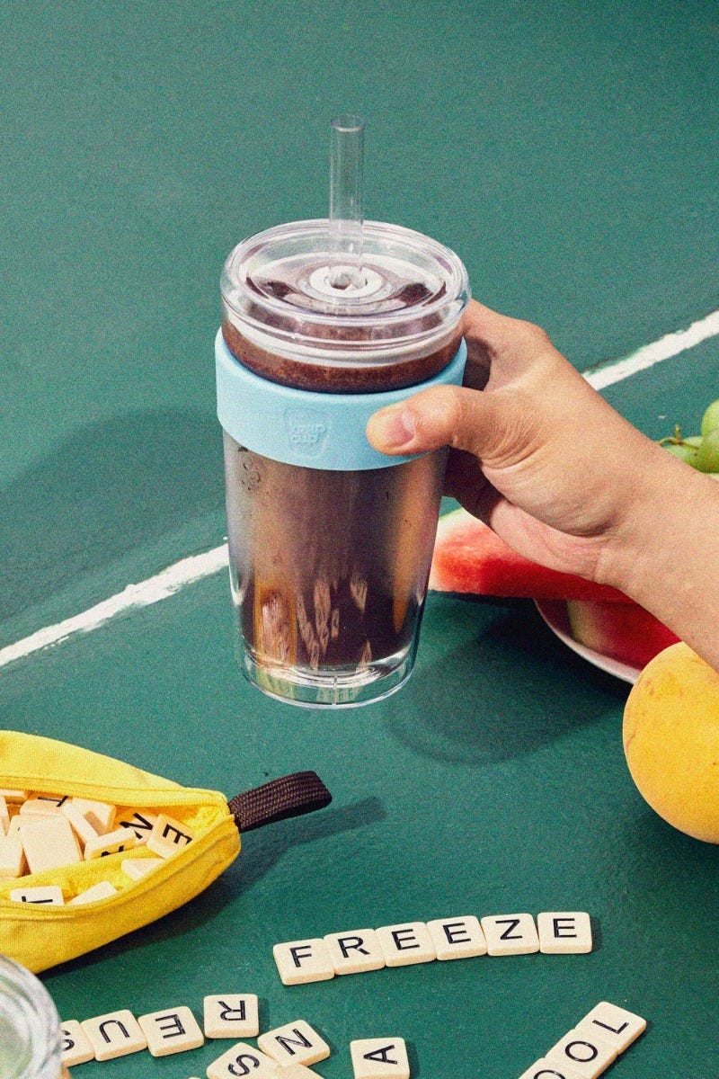 Woman holding KeepCup Sip & Chill longplay reusable glass cup