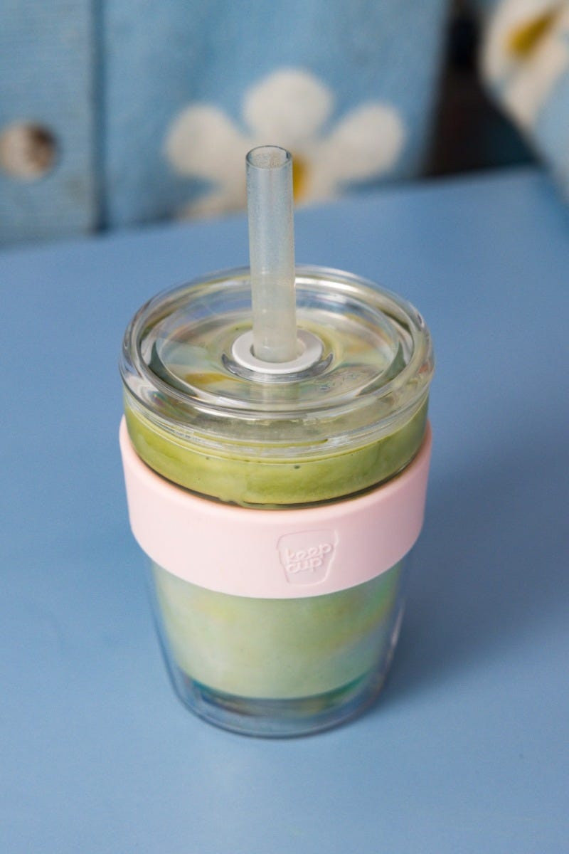 Woman holding KeepCup Sip & Chill longplay reusable glass cup