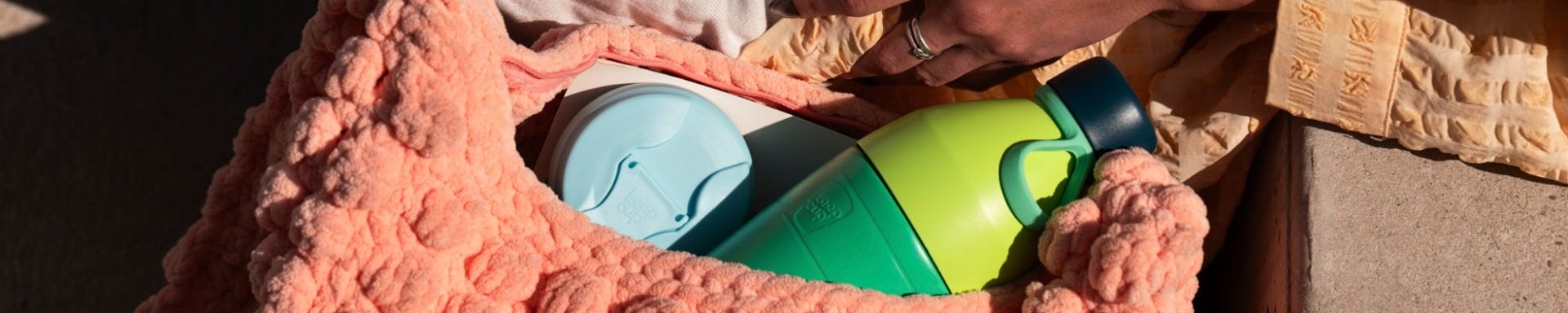 KeepCup Just Essentials gift bundle in Eden Cloud in woman’s handbag